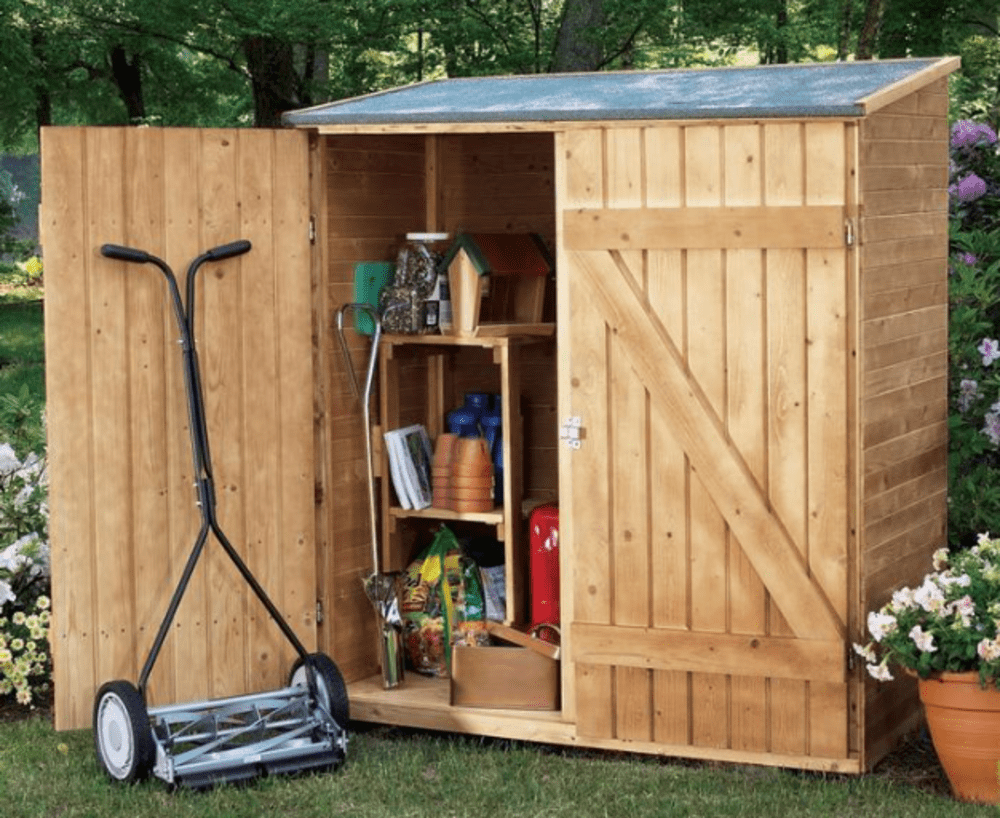 Wooden garden shed with open doors showing organized tools and supplies, next to a manual lawn mower.
